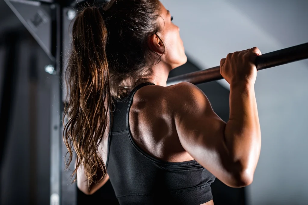 Close-up of woman doing pull-up