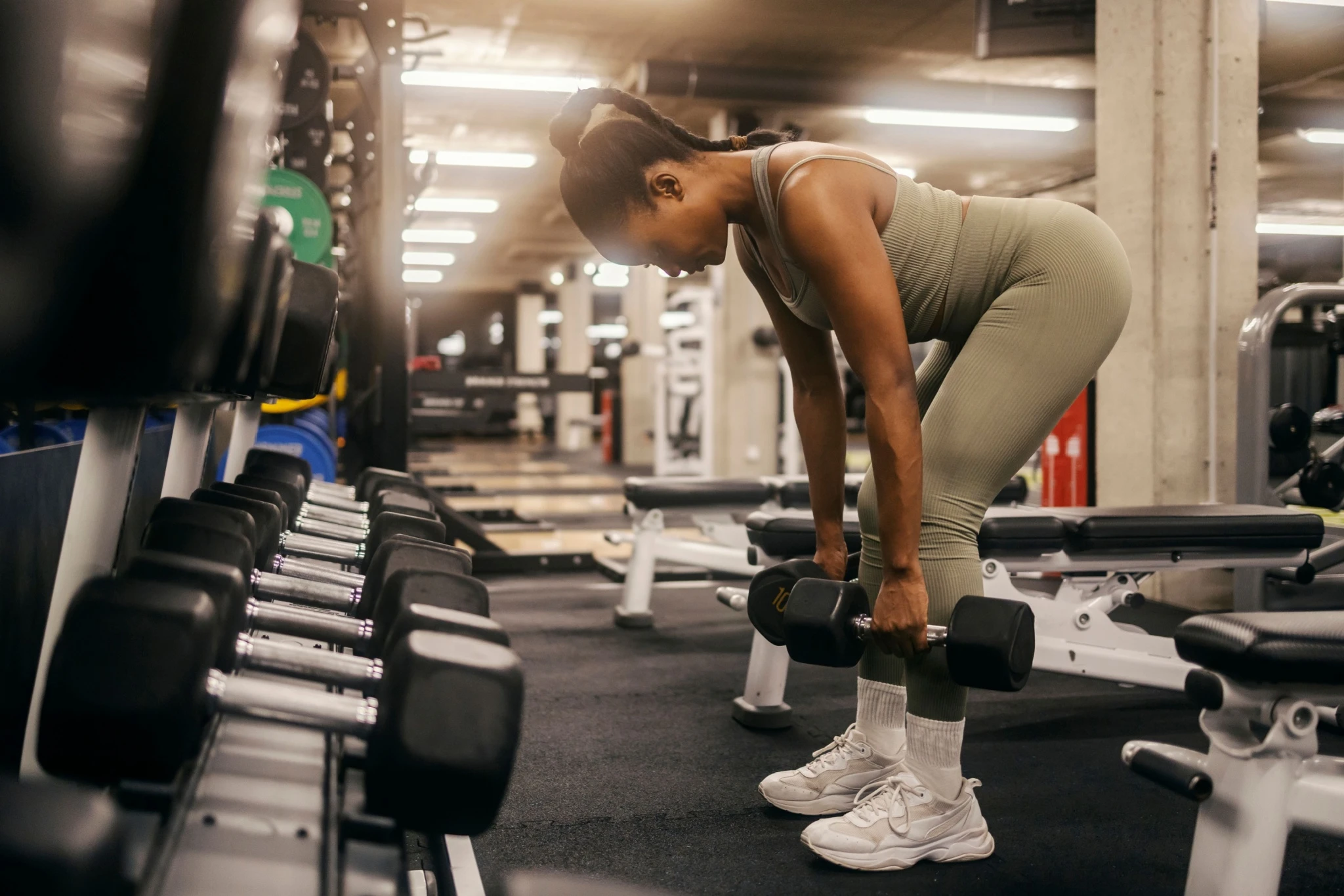 Woman doing dumbbell deadlift