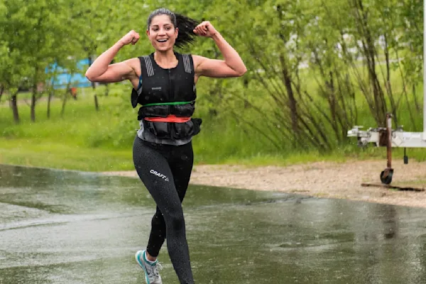 Woman running with weighted vest