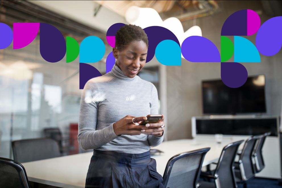 Woman smiling while looking at her phone