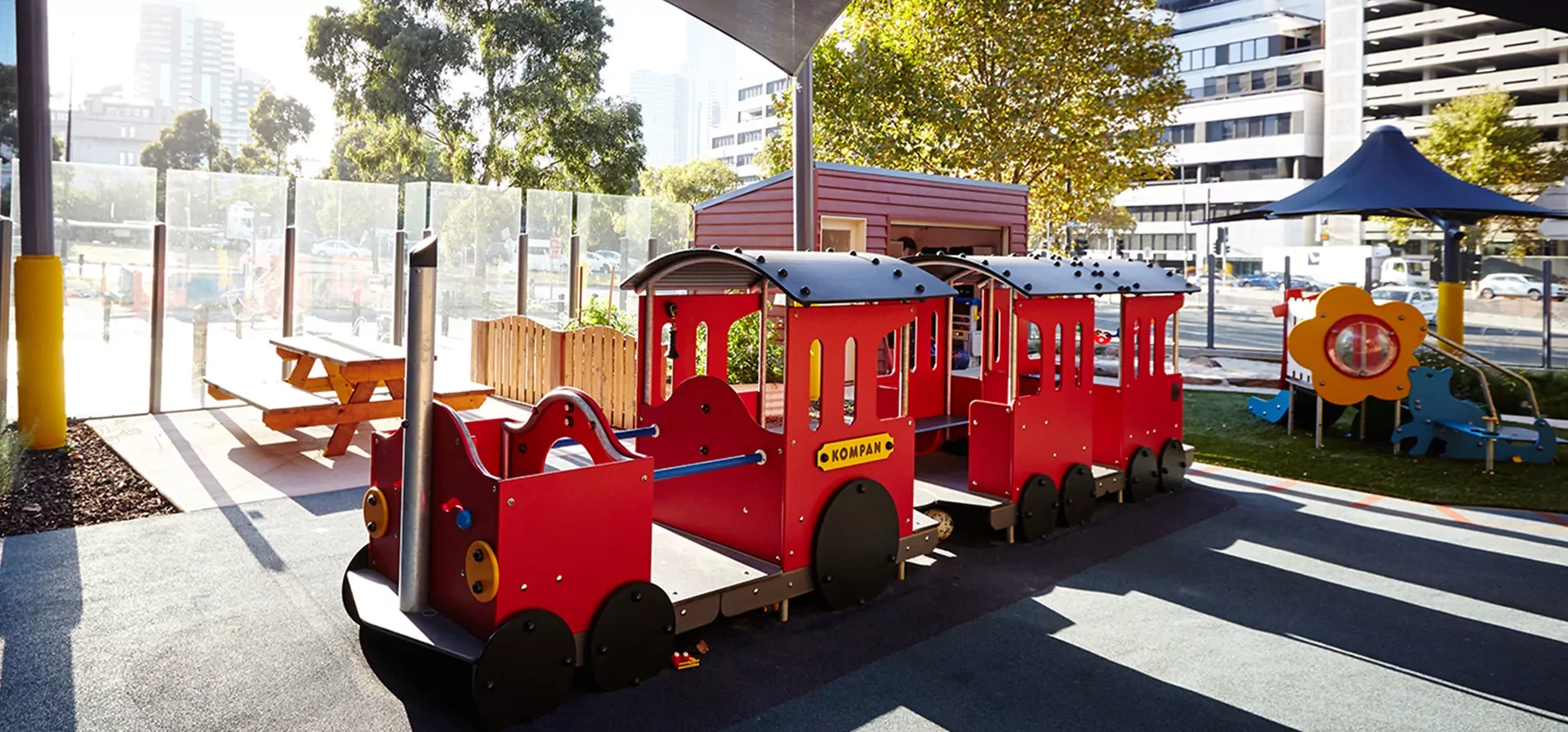 hero image of playhouses and themed playground equipment shaped as a train