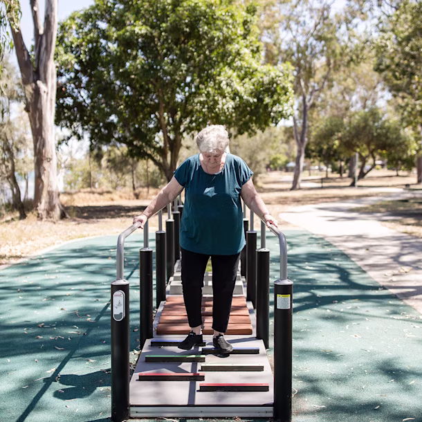 man working out on an outdoor stationary cardio bike