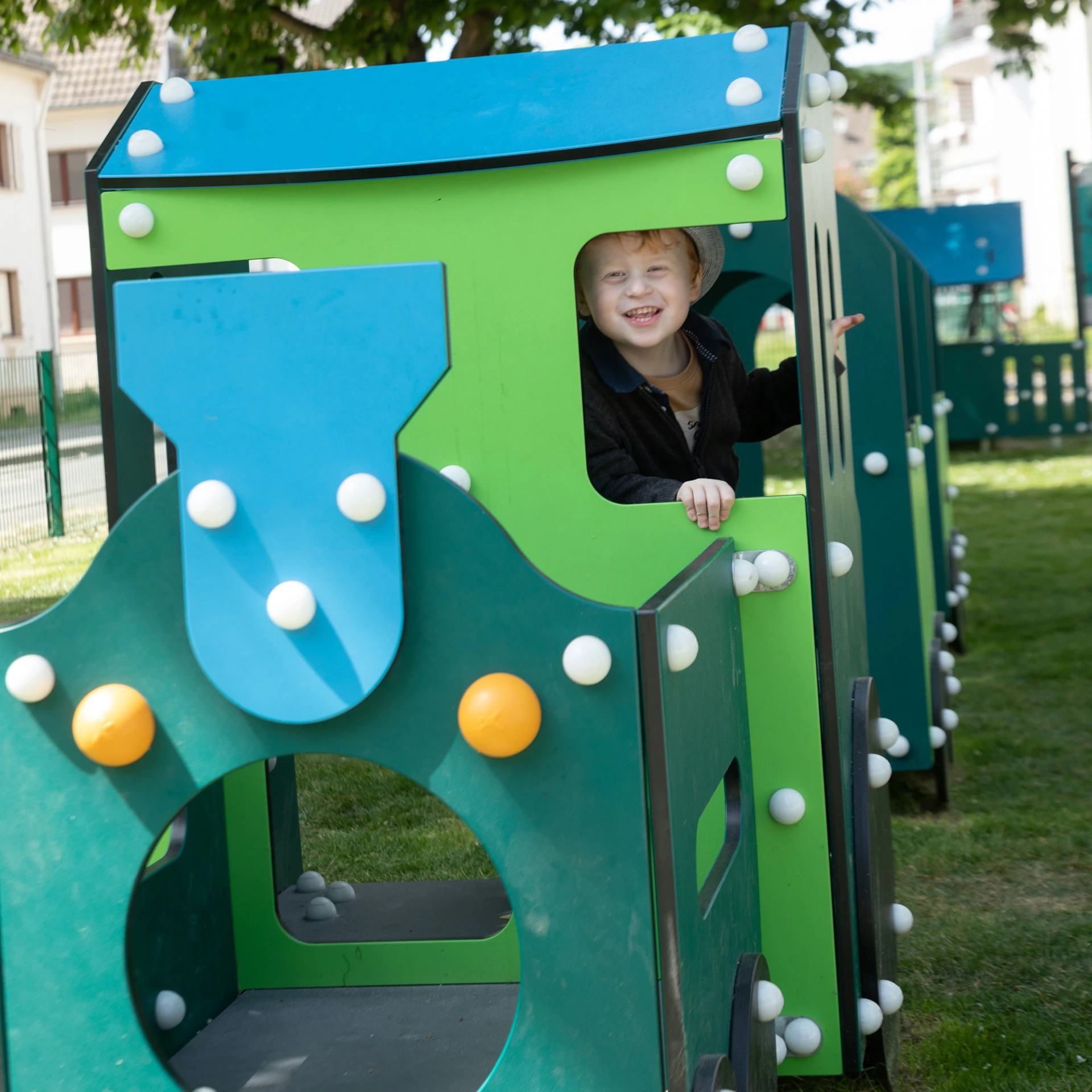 A child playing on a sustainably made train play structure