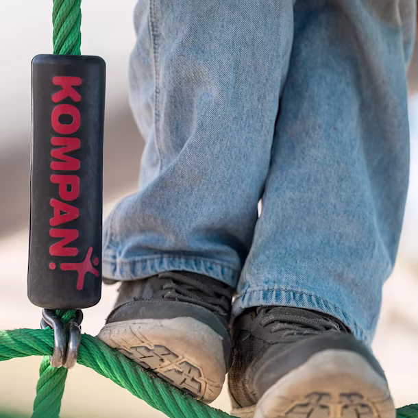Kids standing on a rope play structure