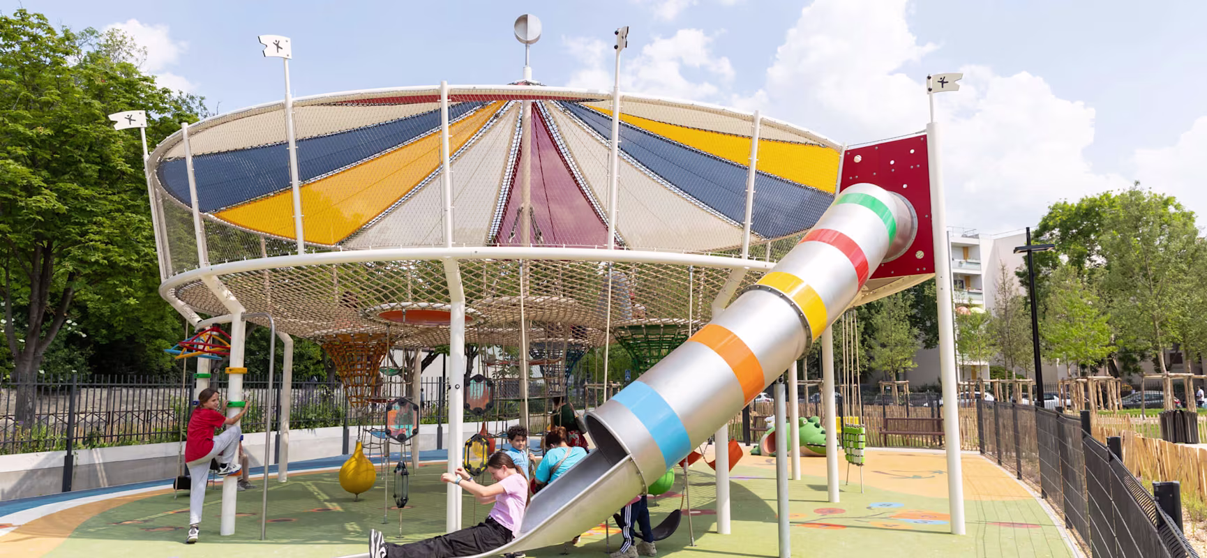 Carnival themed playground with kids sliding down a large slide
