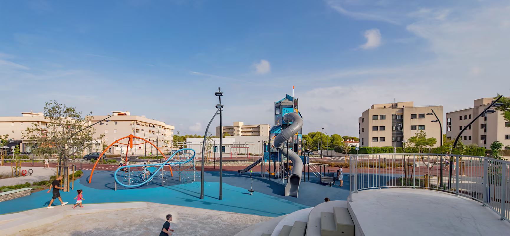A children's playground with a slide and swings.