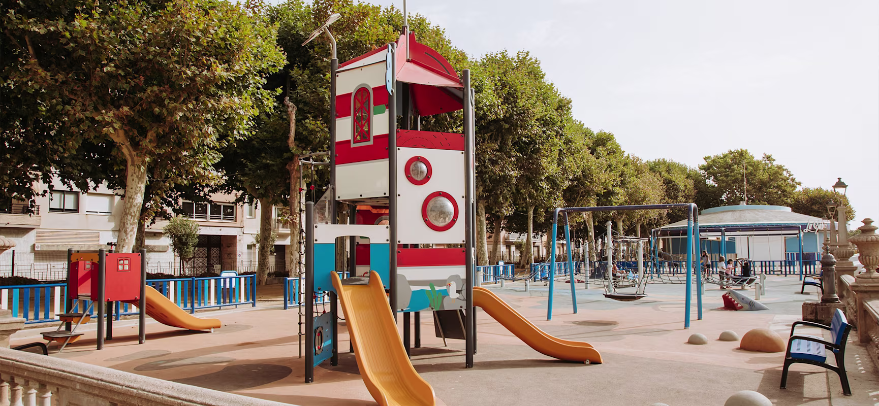A playground with a slide and a tower.