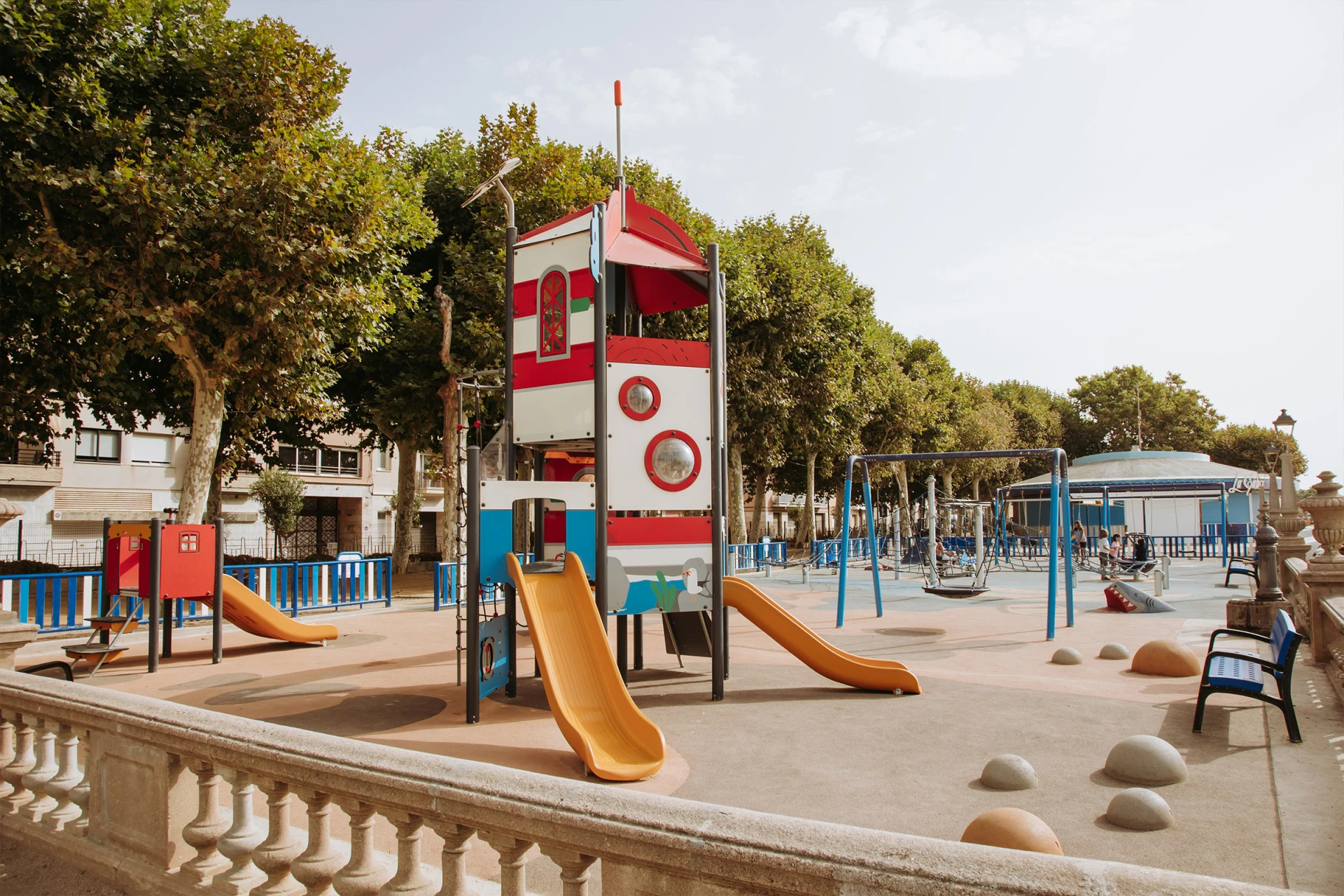 A playground with a slide and a tower.