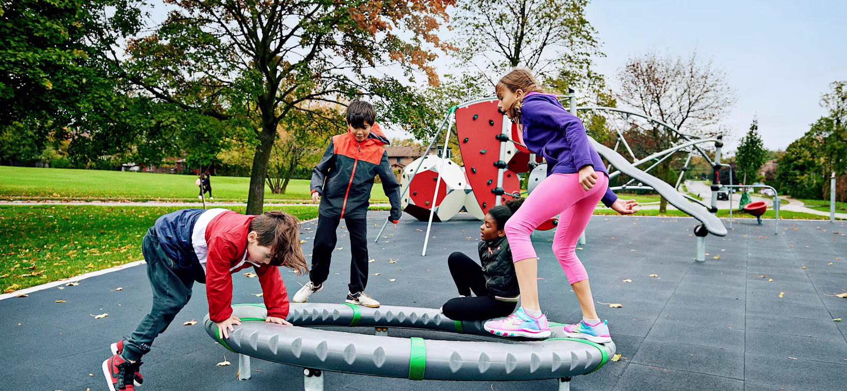 Children in Morgan Boyle Park playing on a supernova spinning playground equipment