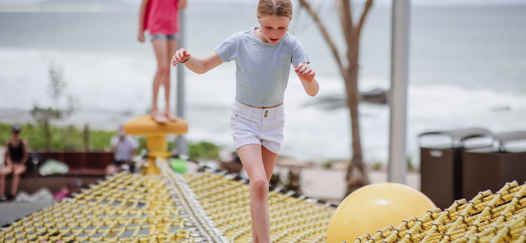 a young girl balancing and climbing