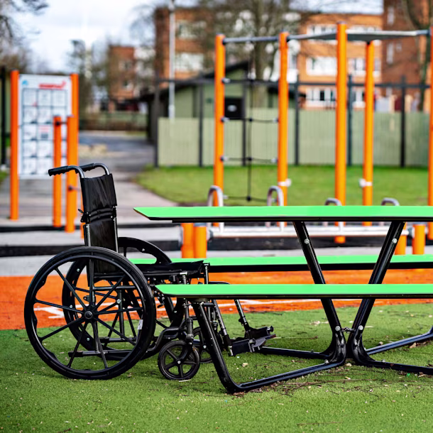 Green bench and table set at a playground