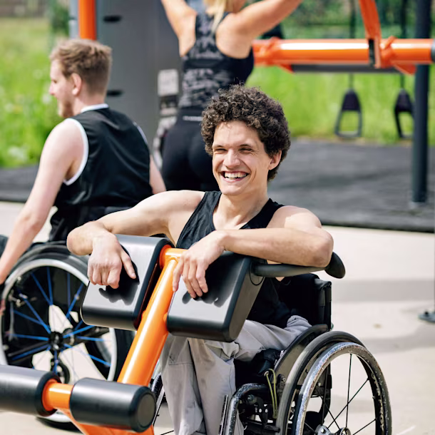 A man in a wheelchair using and inclusive outdoor gym