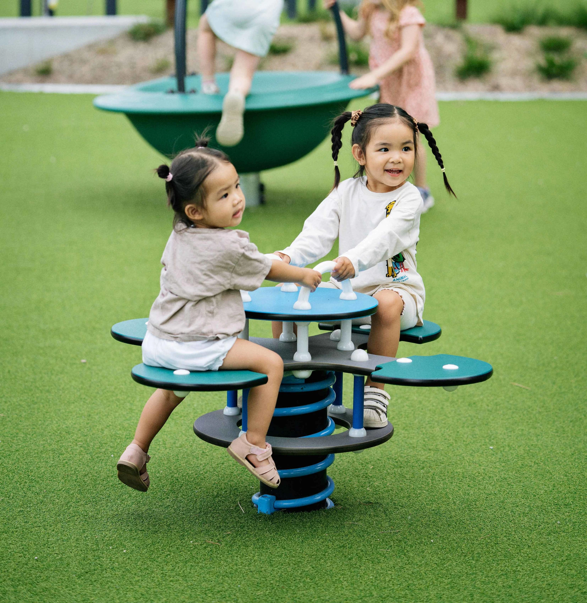 Toddlers playing on KOMPAN playground equipment