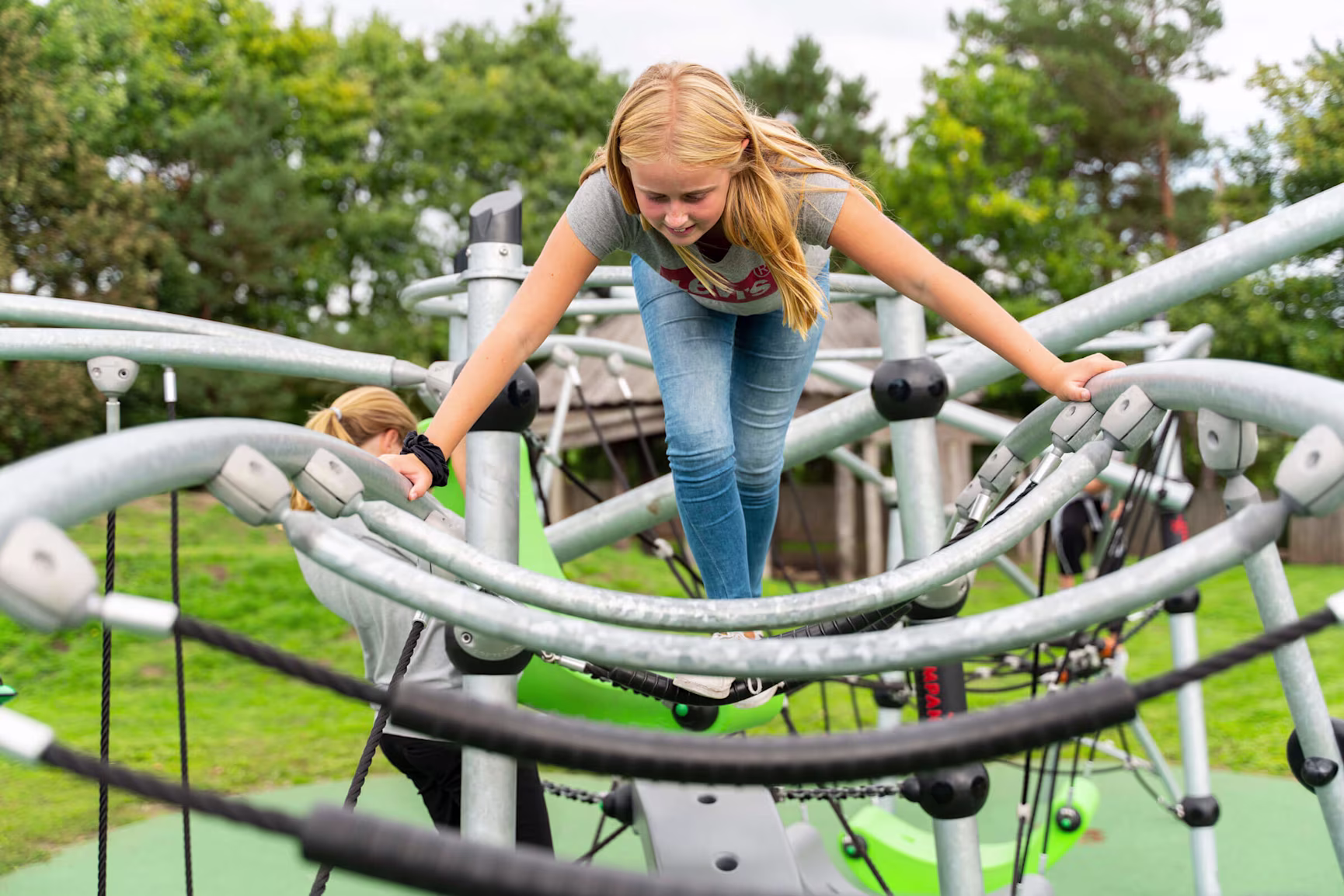 girl climbing on GALAXY play system for teens at Hældager School