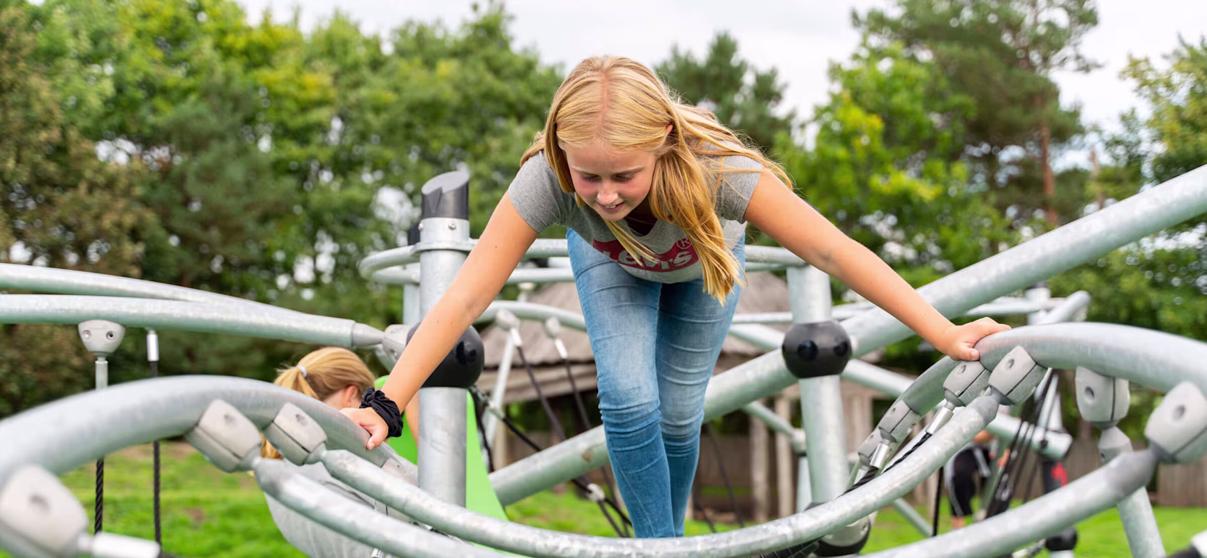 girl climbing on GALAXY play system for teens at Hældager School