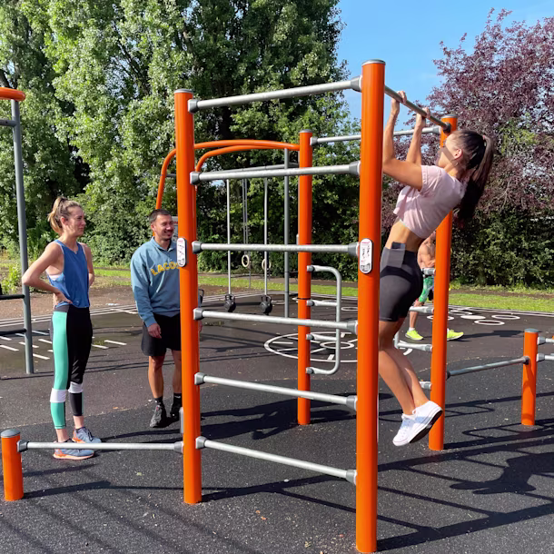 students working out at a outdoor gym at their university