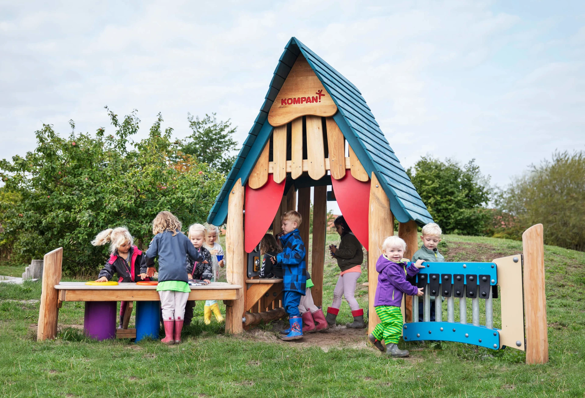 Children engaging in stimulating play with wooden play panels