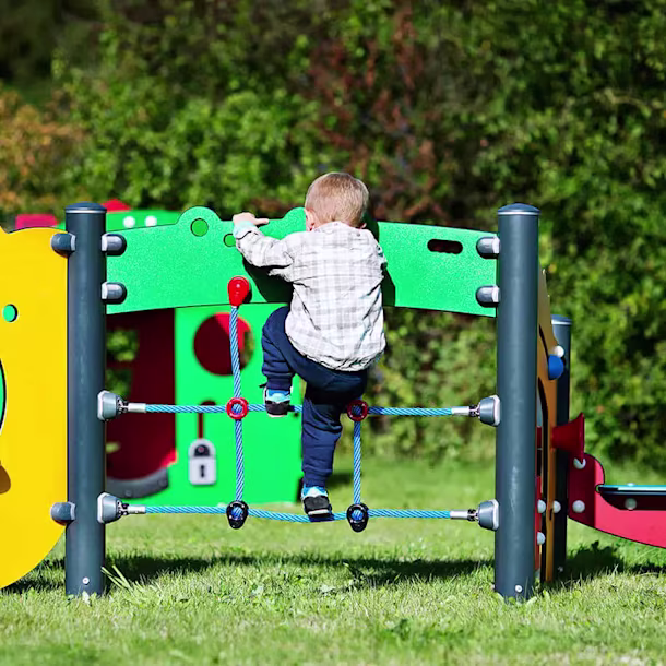 Toddler climbing on a play system designed for toddlers