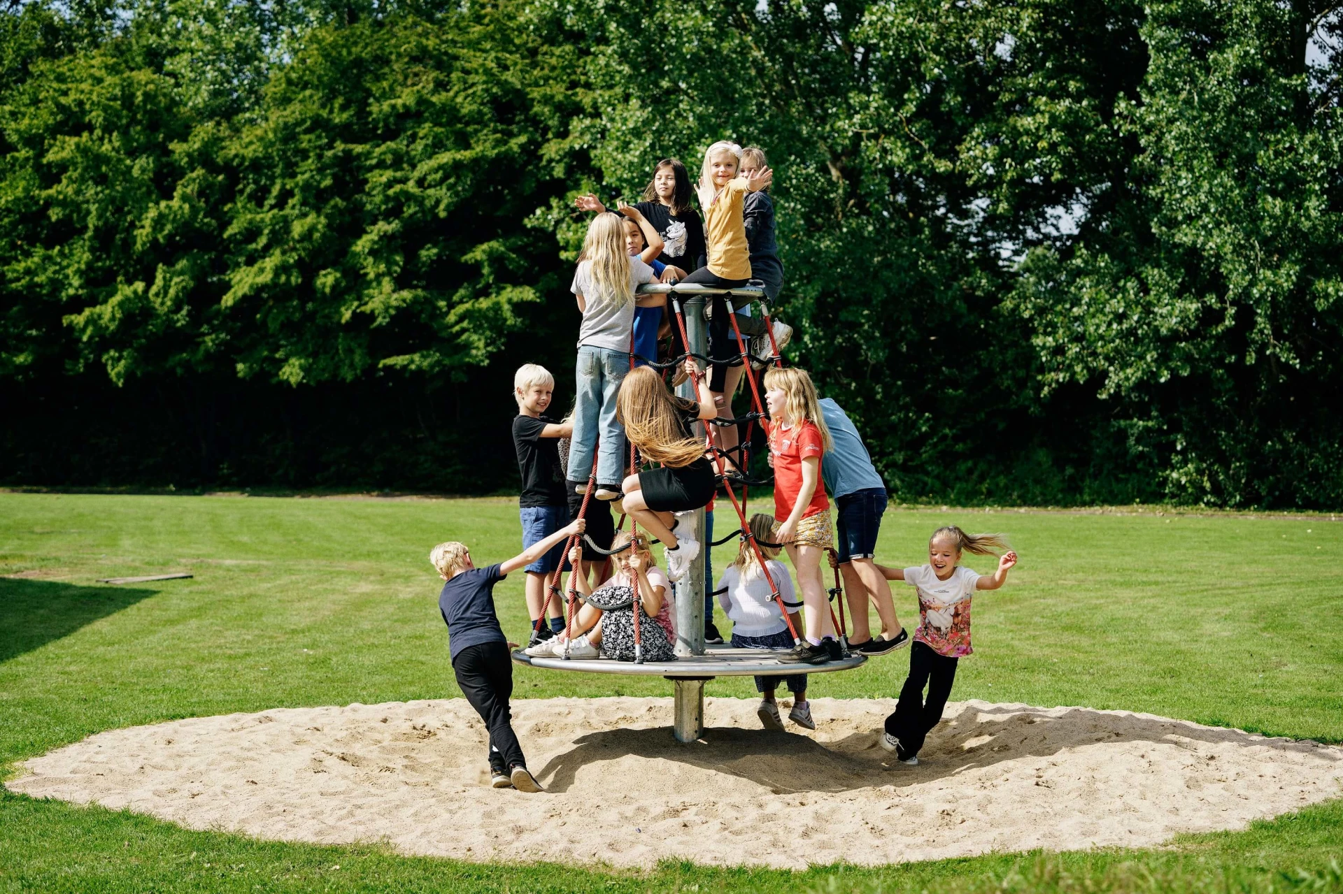 A group of children climbing and spinning on a Twisting Net