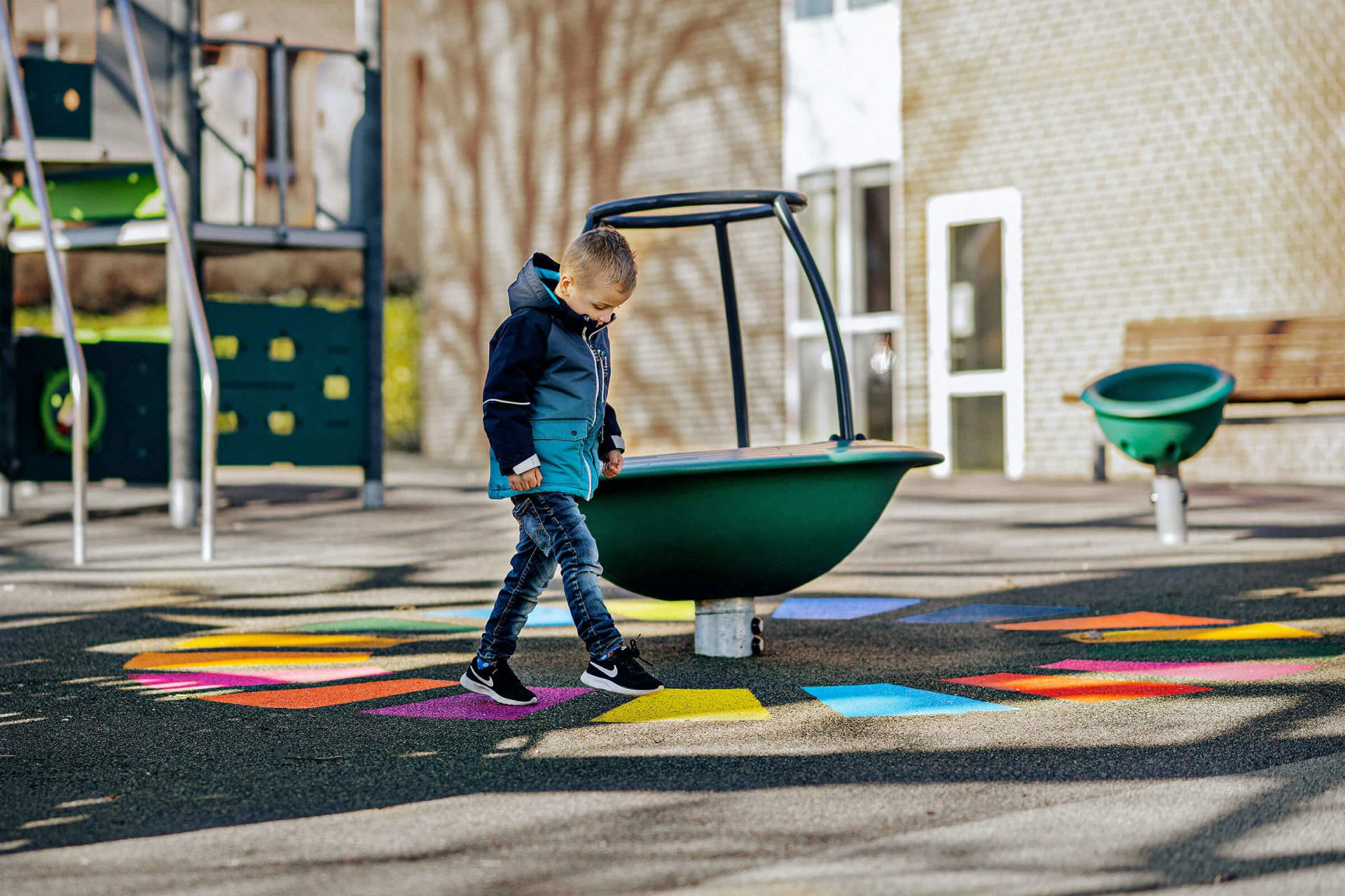 A boy playing on a low carbon emission playground
