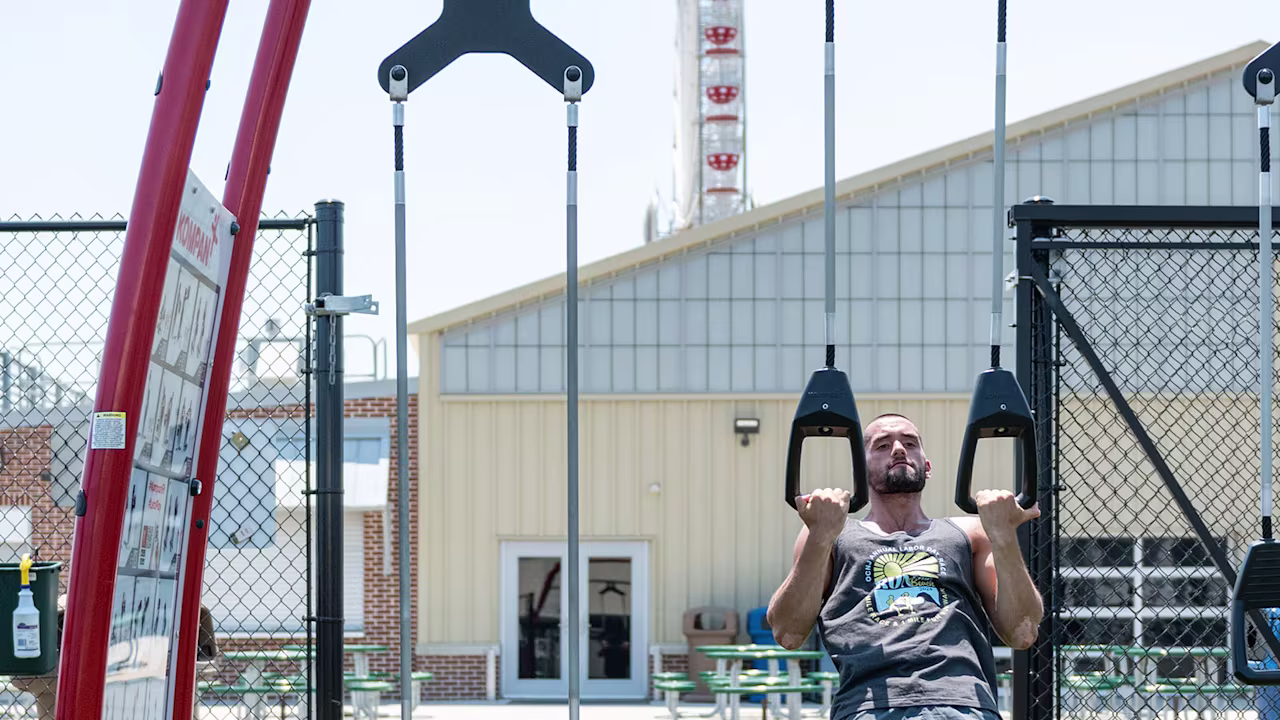 people using an outdoor park gym for functional fitness training hero image