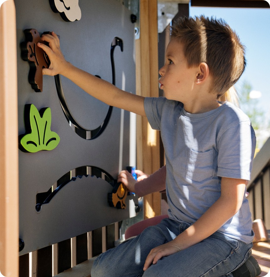 boy playing on play panels on a robinia infinity sculpture