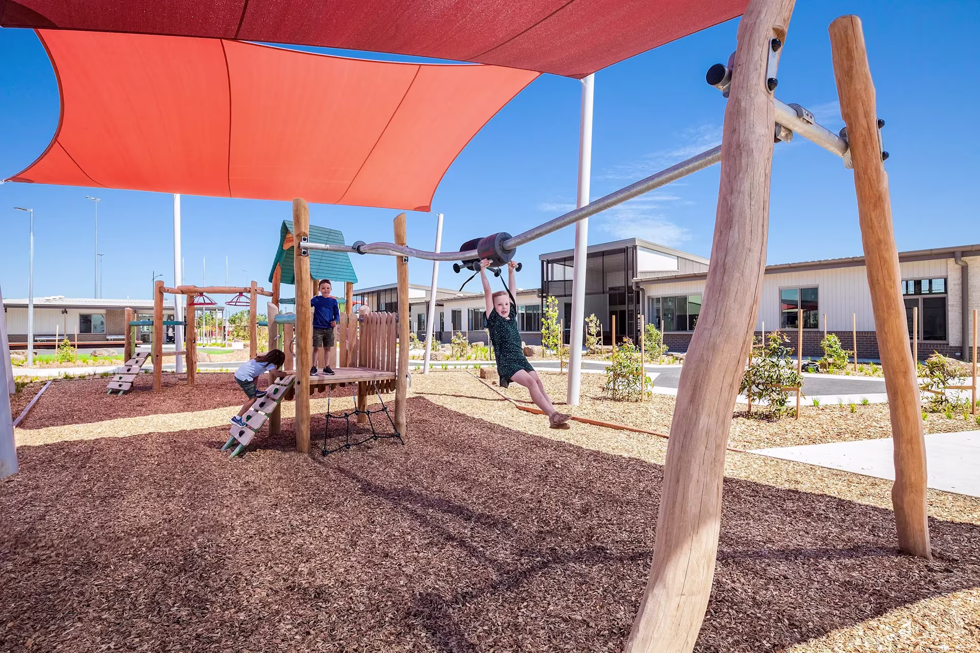 Girl looking through binoculars on a playground