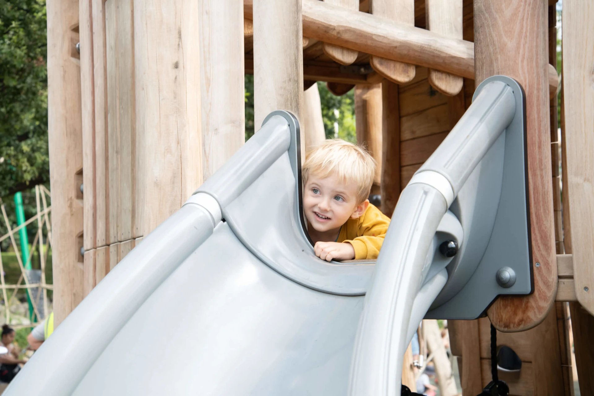 Child at kindergarten playing in a play tower