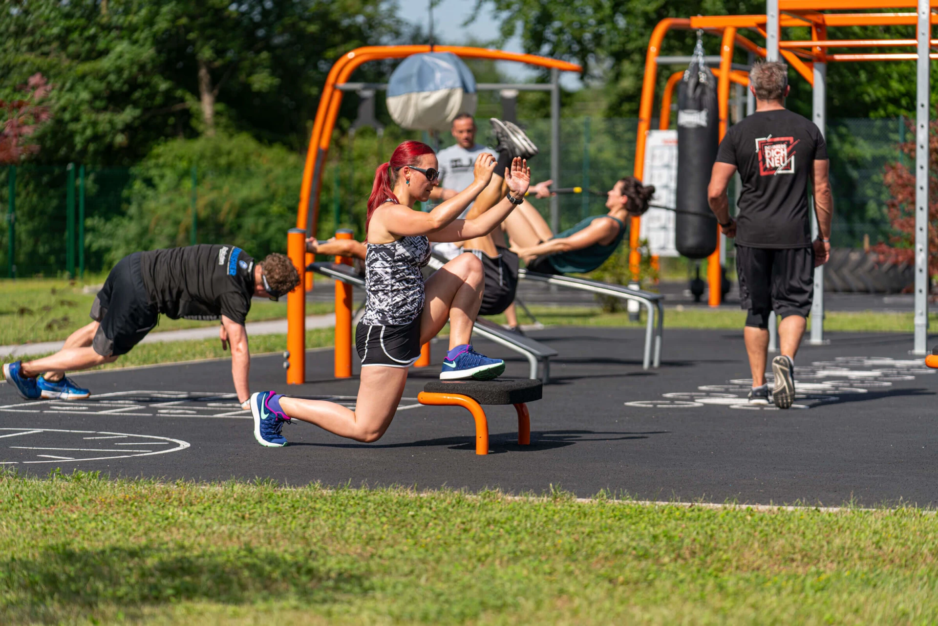 People working out on calisthenics and functional outdoor training systems