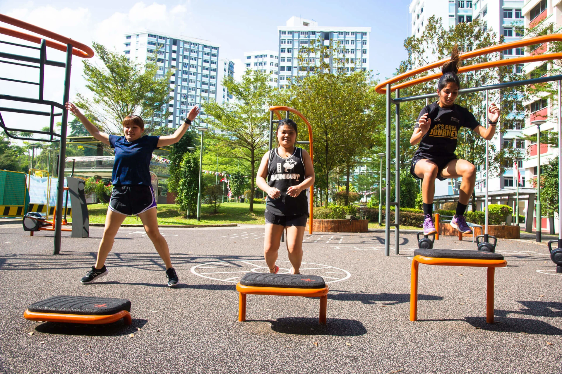 women working out together at outdoor fitness site in Singapore