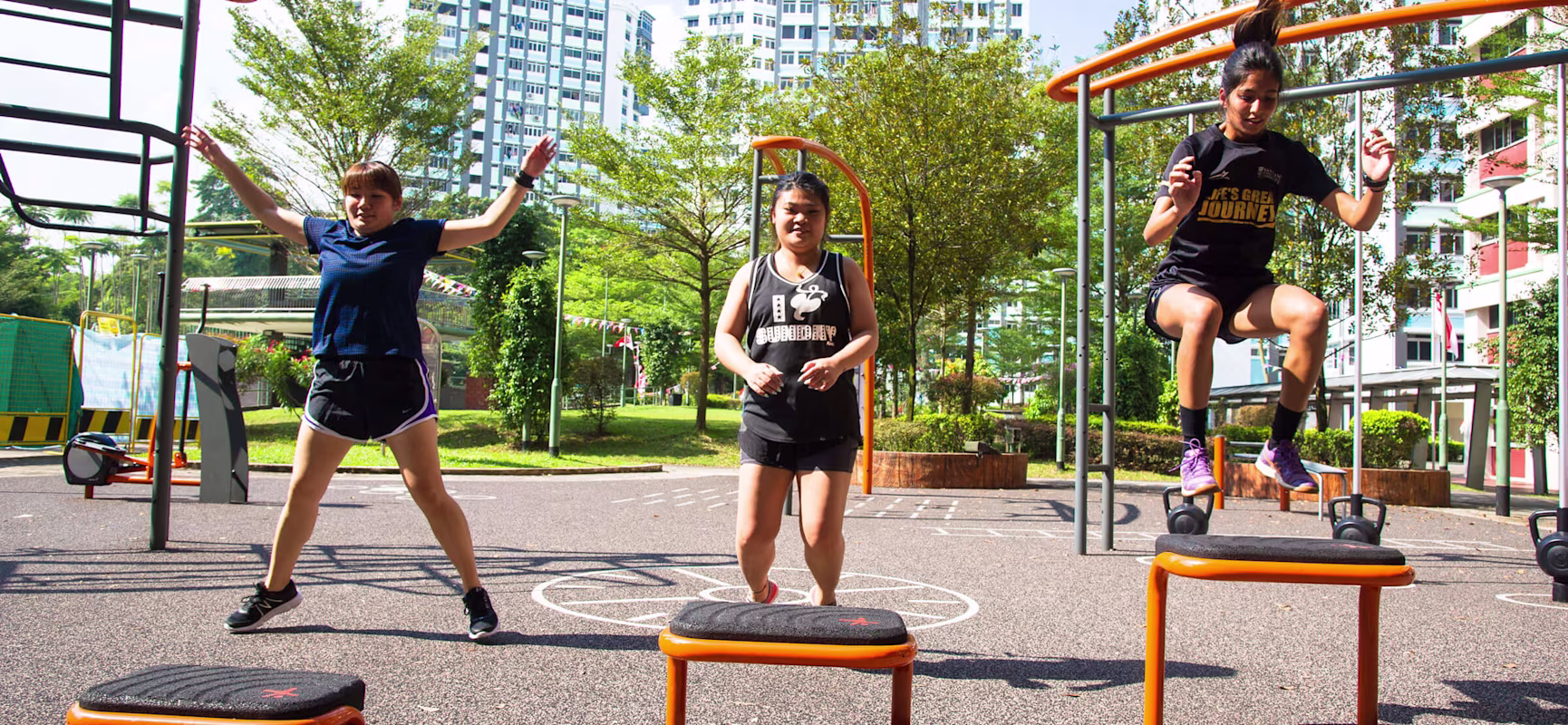 women working out together at outdoor fitness site in Singapore