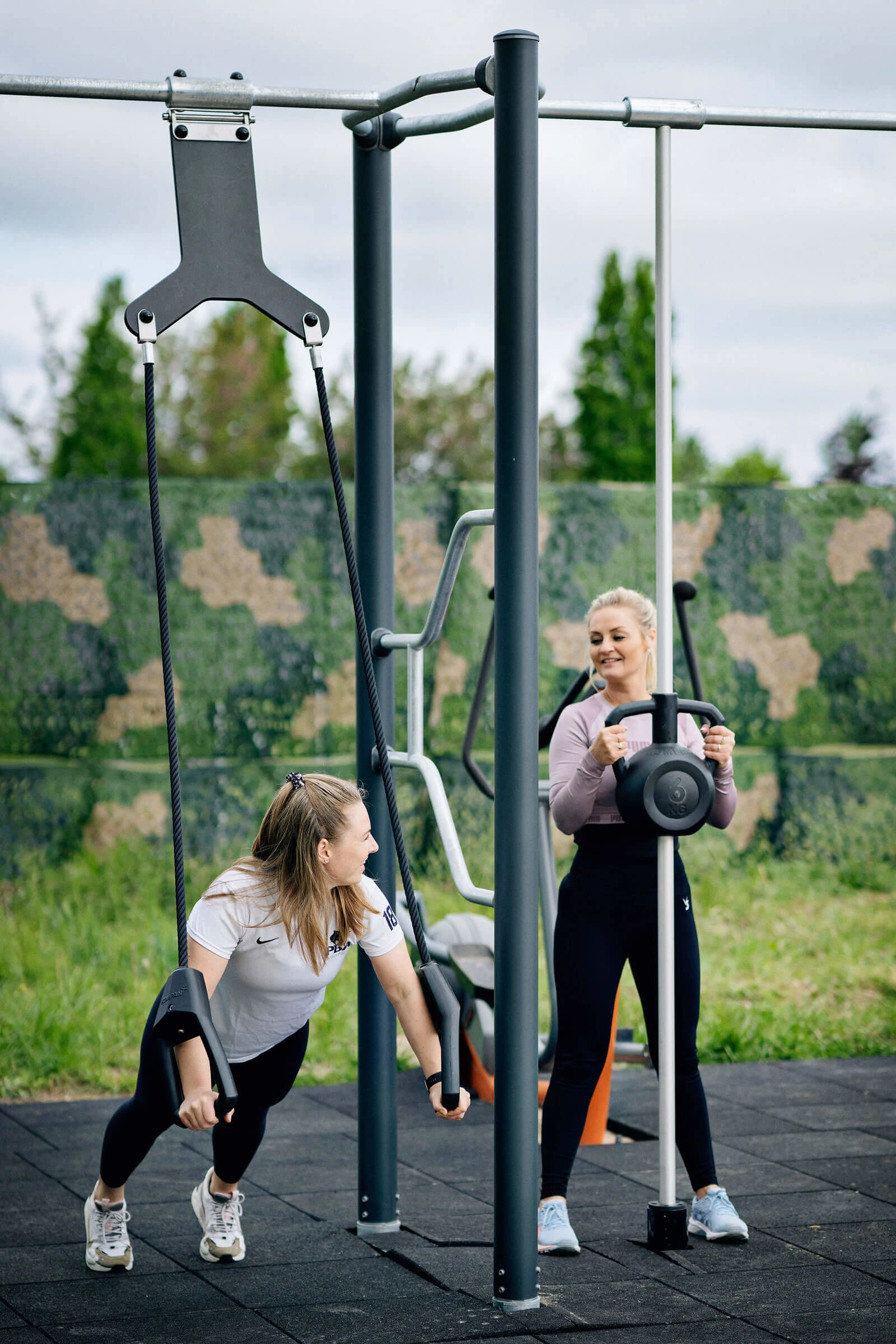Women working out on compact function training system 