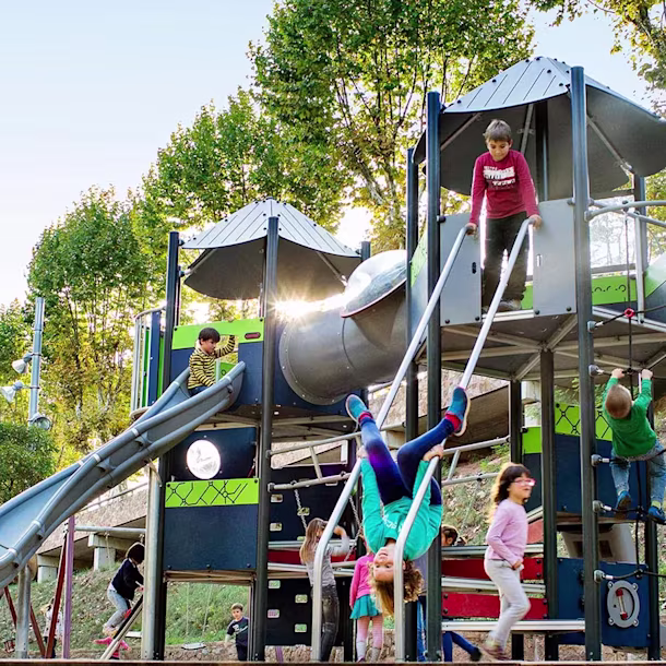 hero image of school children playing on moments play system