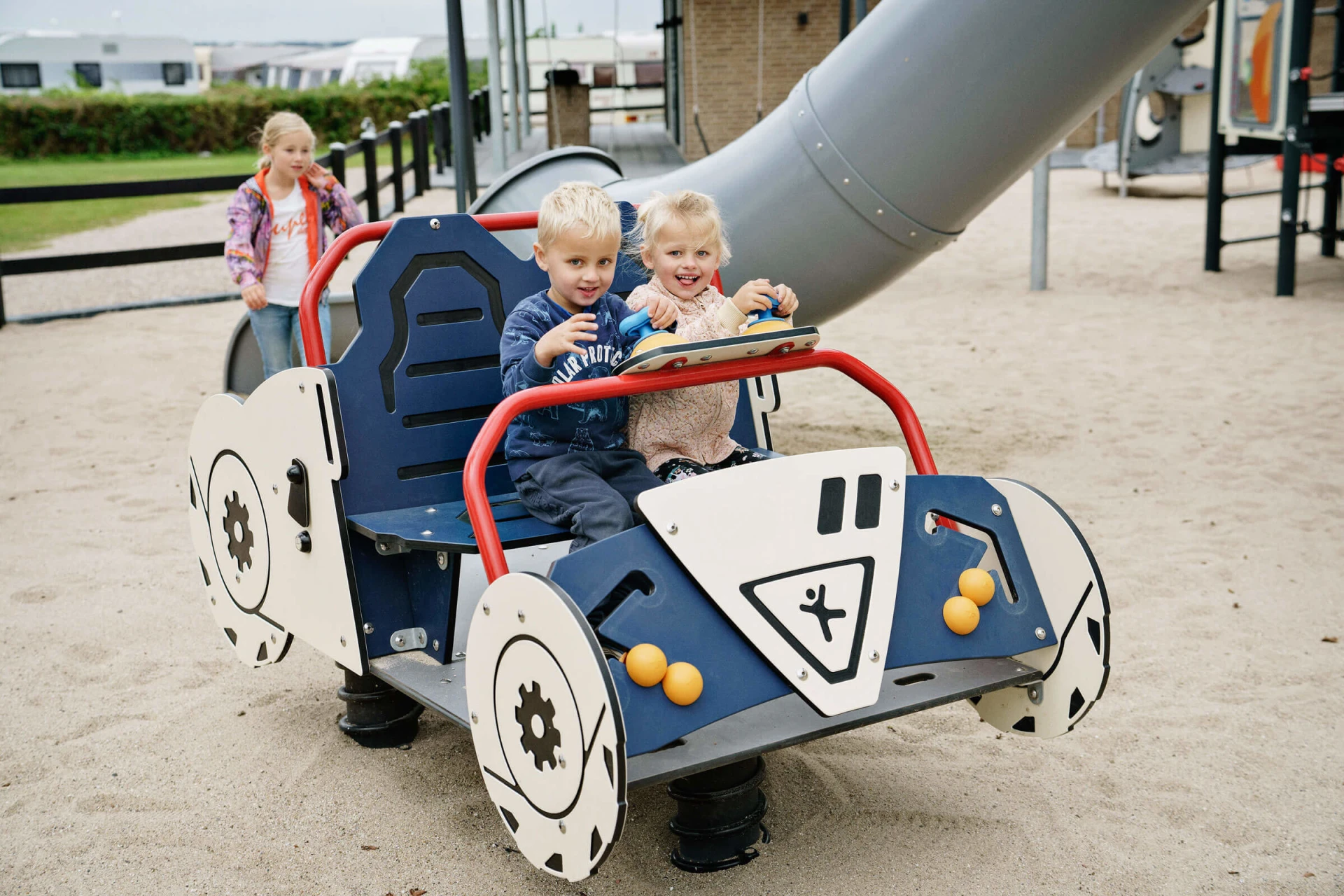 Kinder, die auf einem Spielplatz mit einem thematischen Spielplatzgerät spielen