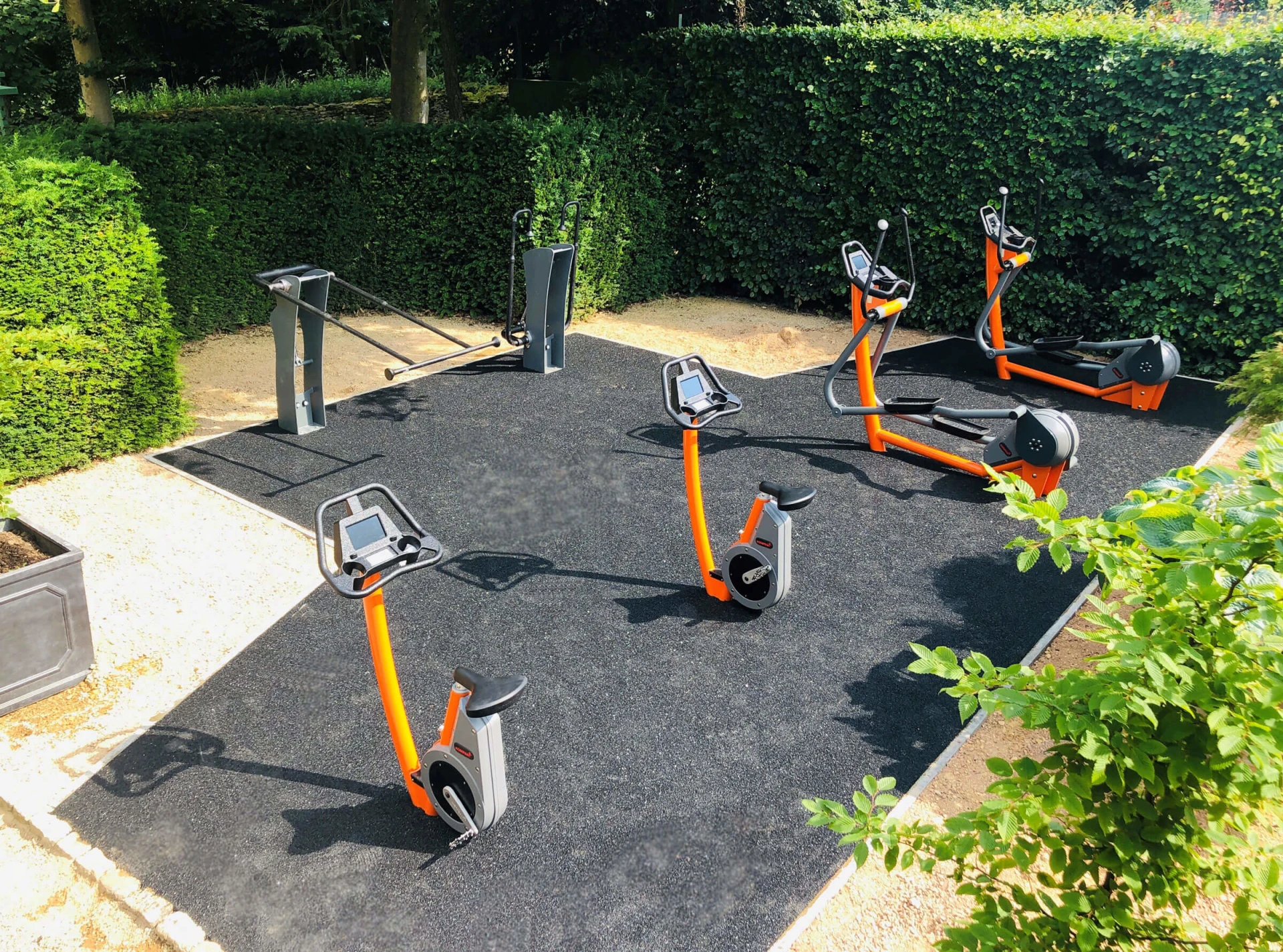 outdoor fitness area with stationary cardio equipment