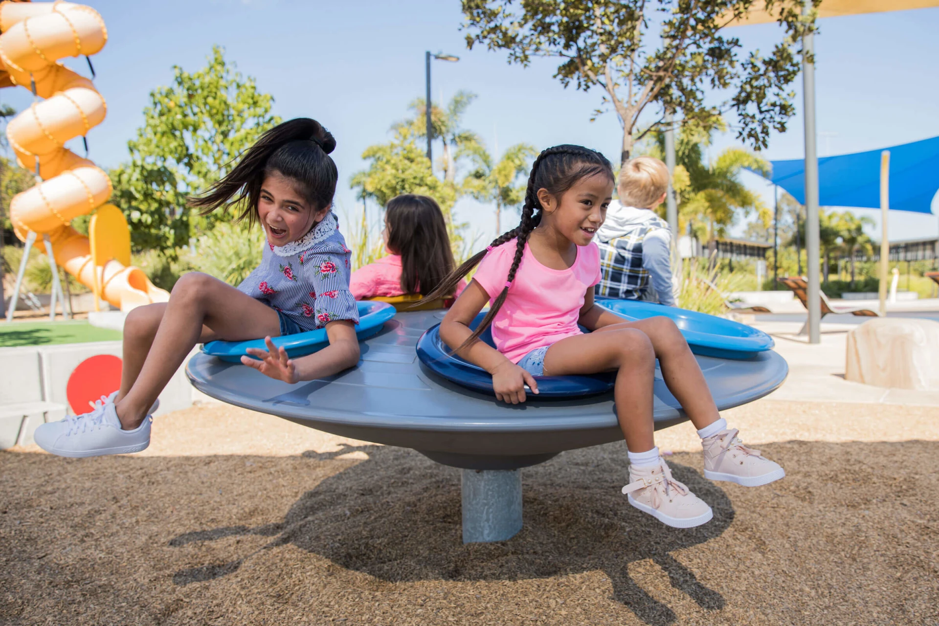 playground equipment kids playing on a carousel spinner