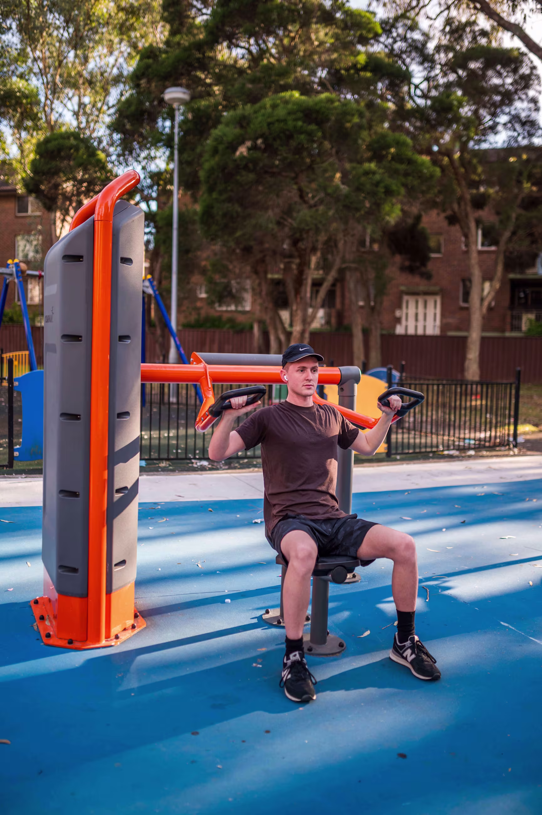man exercising outdoors on outdoor fitness equipment