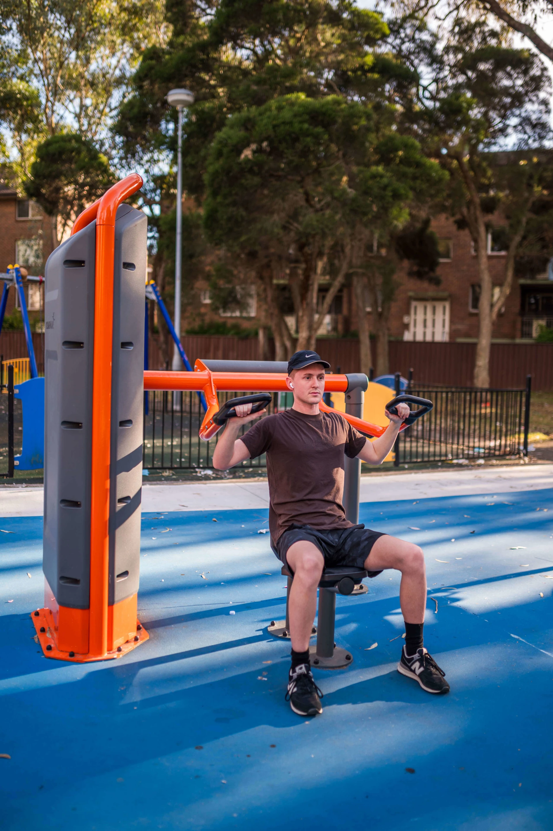 man exercising outdoors on outdoor fitness equipment