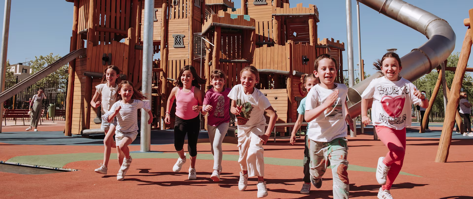 contact KOMPAN top slider image of girl sliding down a playground slide
