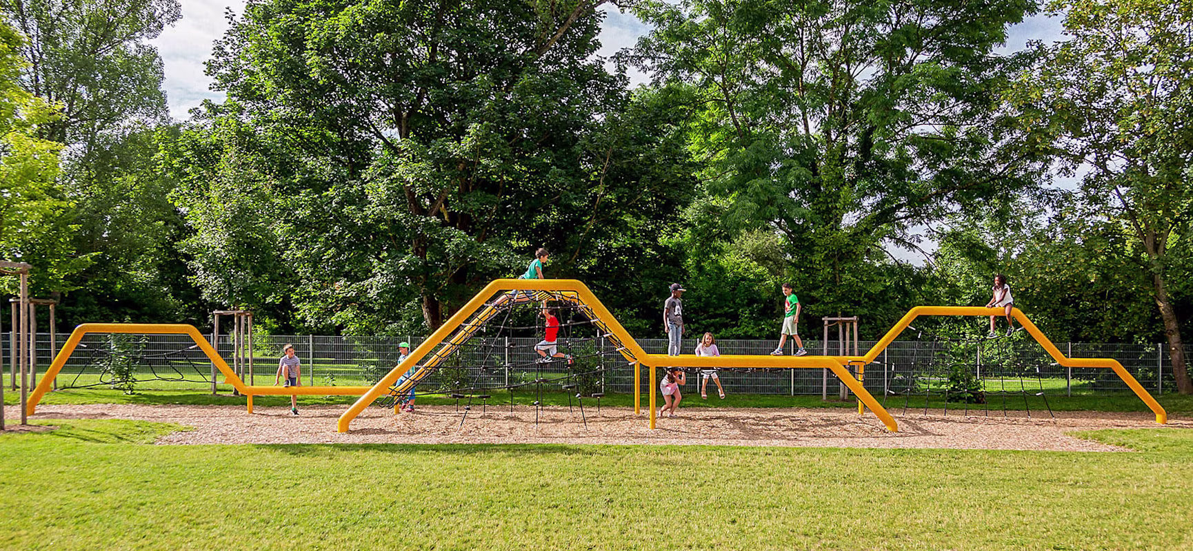 Children playing on a rope climbing structure at school in Munich
