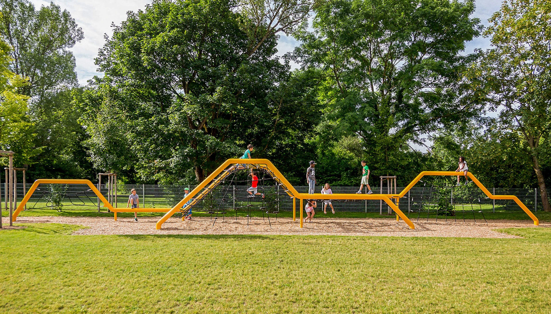 Children playing on a rope climbing structure at school in Munich