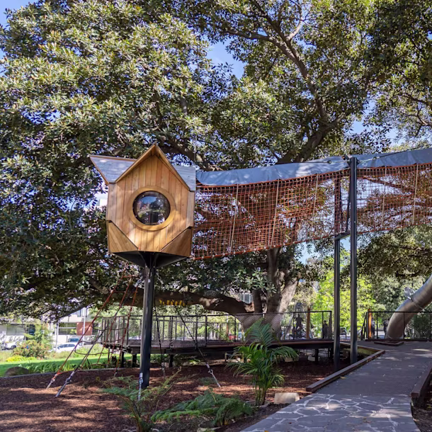 A tree house playground tower in the middle of a park in Melbourne