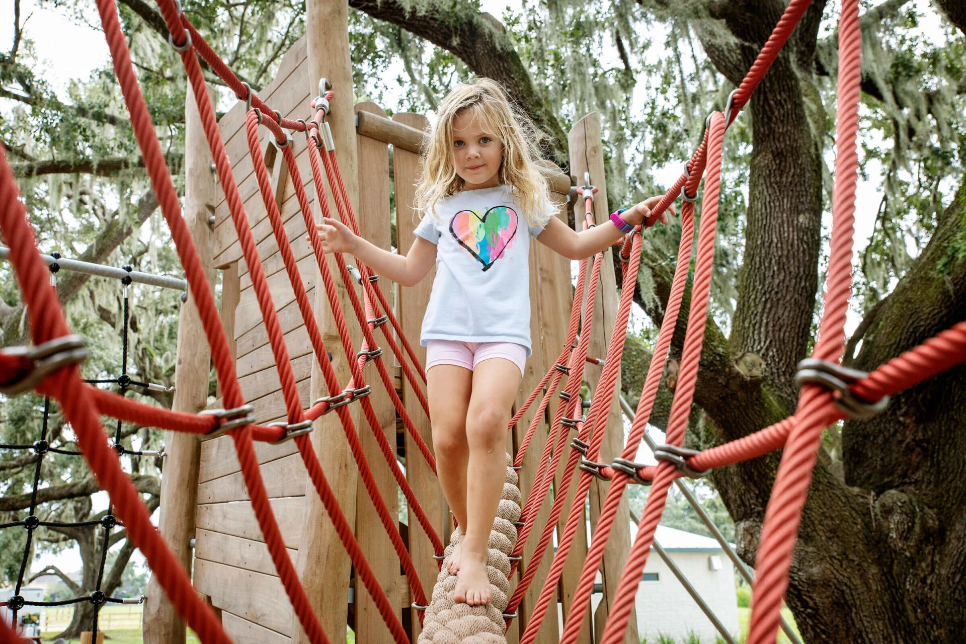 Girl balancing on playground bridge tower at Tucker Ranch