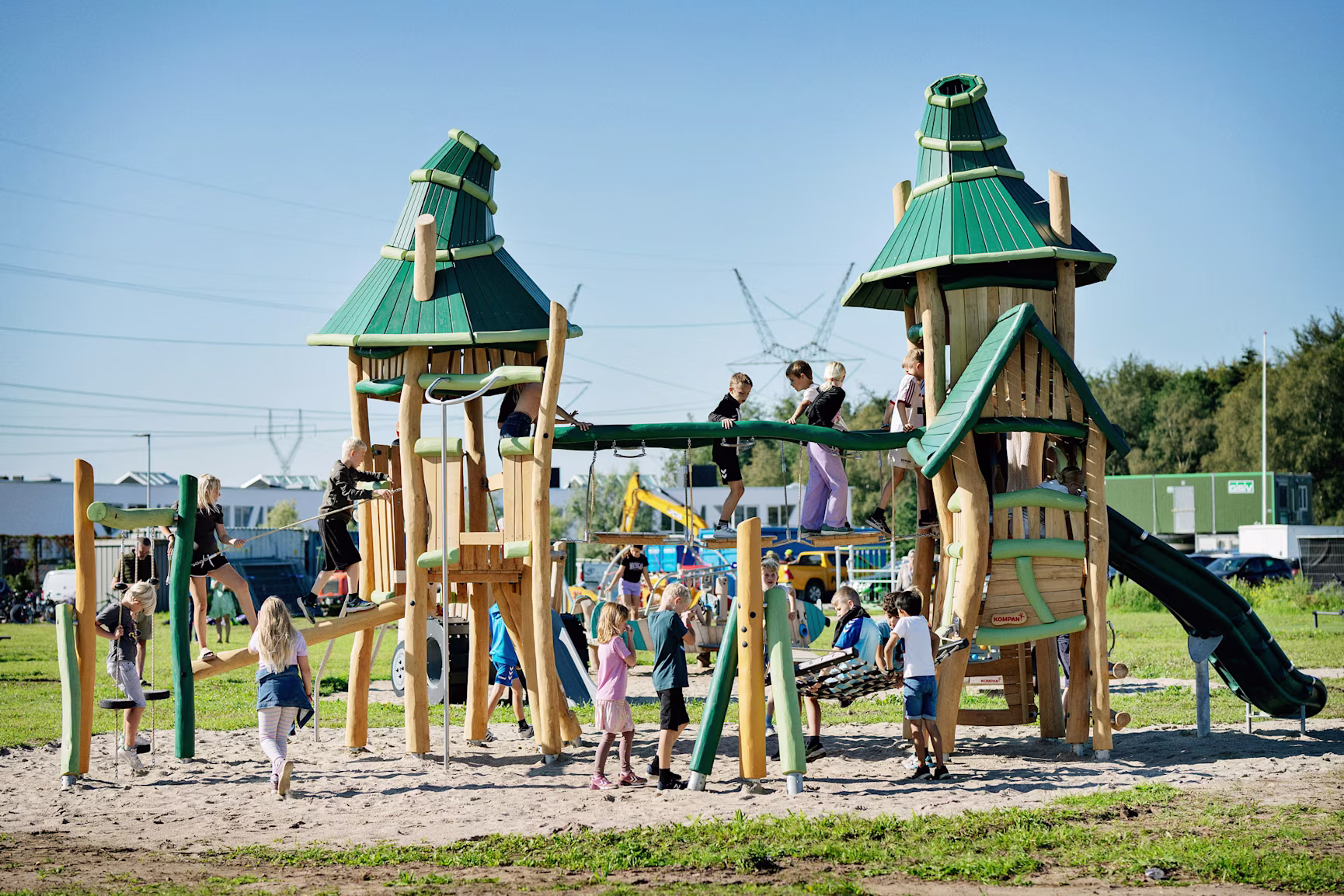 A child playing on a natural wooden playground