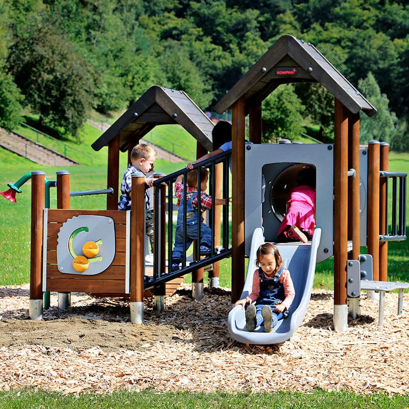 children playing and sliding on moments playground system