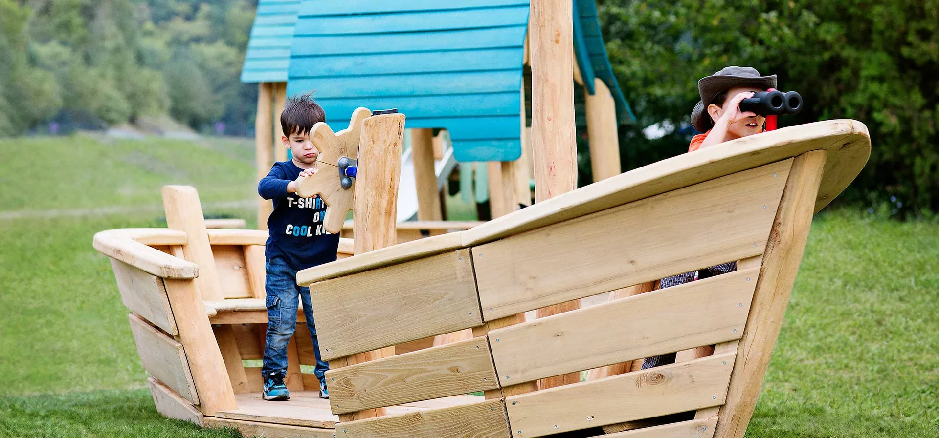 children playing on a wooden boat themed playground robinia themed play hero image