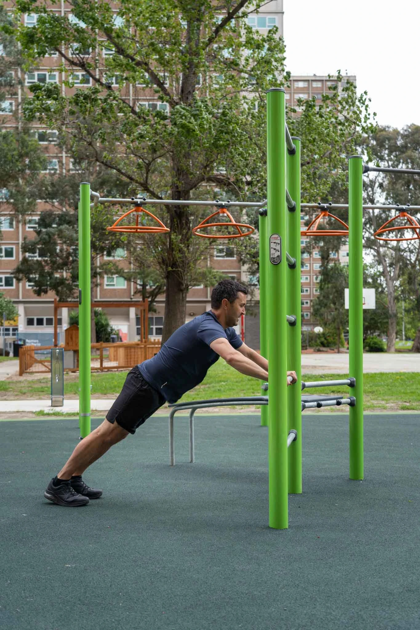 a group of people working out in an outdoor callisthenics gym in a park