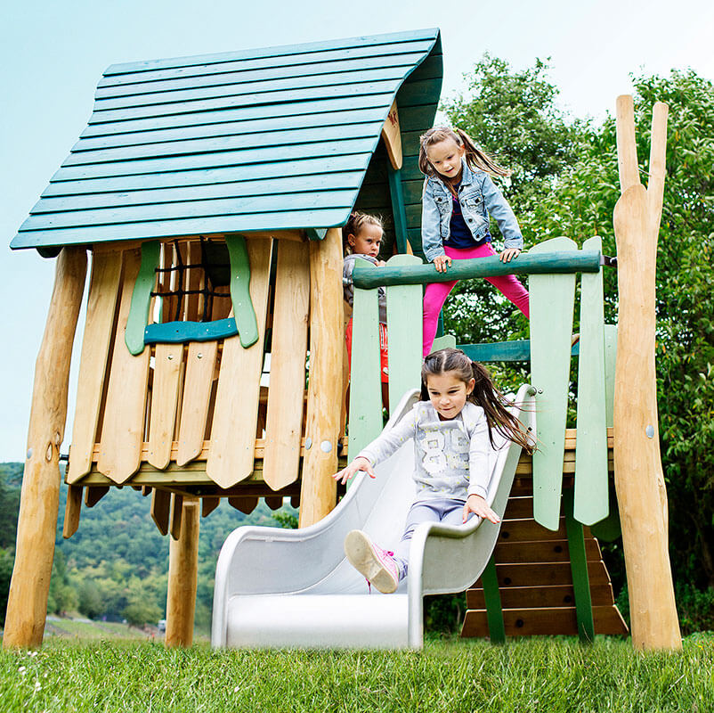 children playing on robinia village wooden playhouse reference image