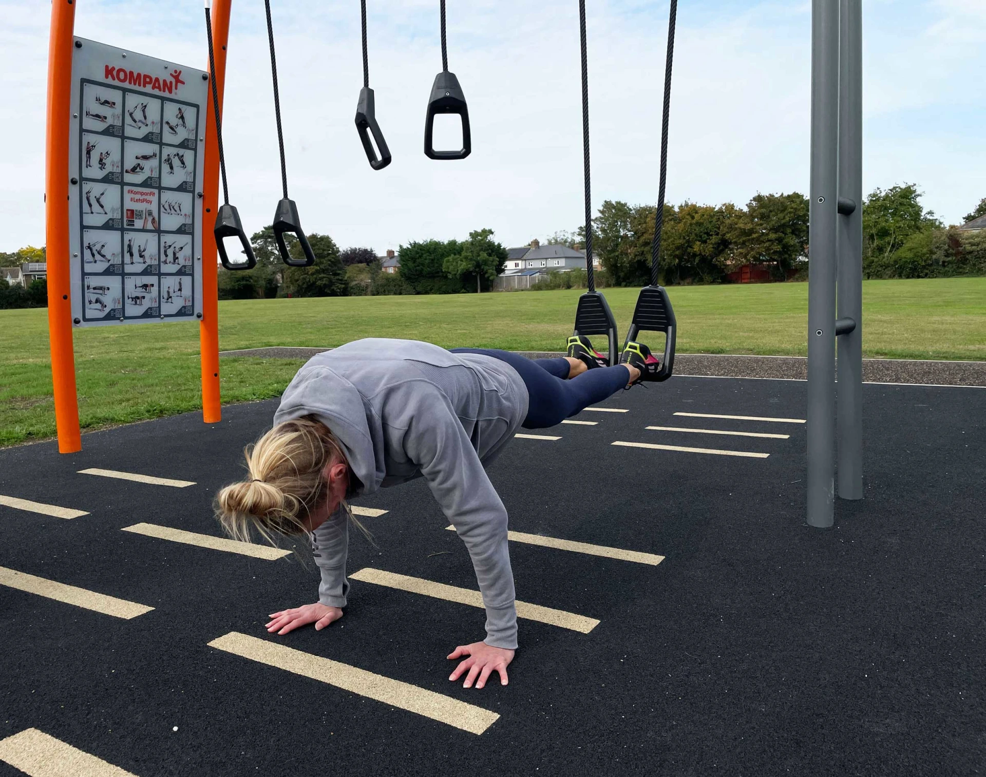 woman working out on outdoor training station