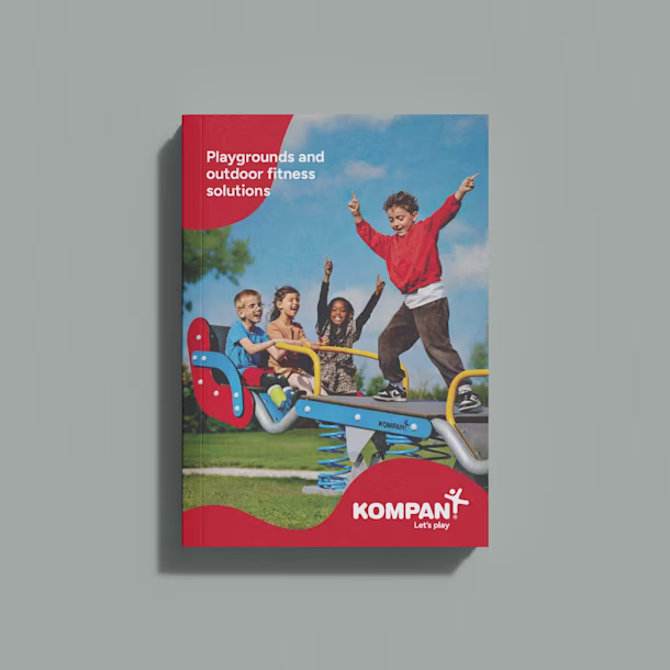 Cover of a Kompan playground catalog showing children playing on a colorful spring rocker in a park under a blue sky